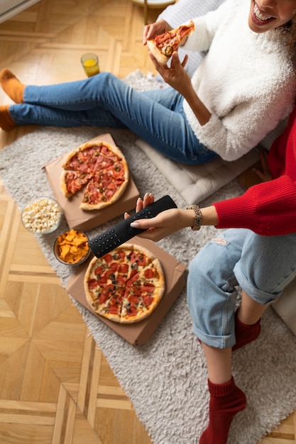 Free photo close up woman holding remote