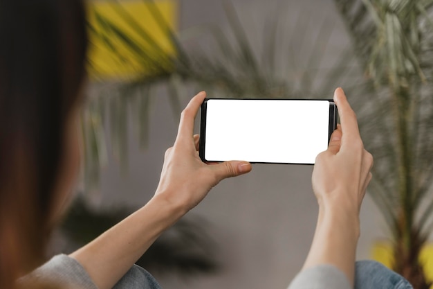 Close-up woman holding smartphone