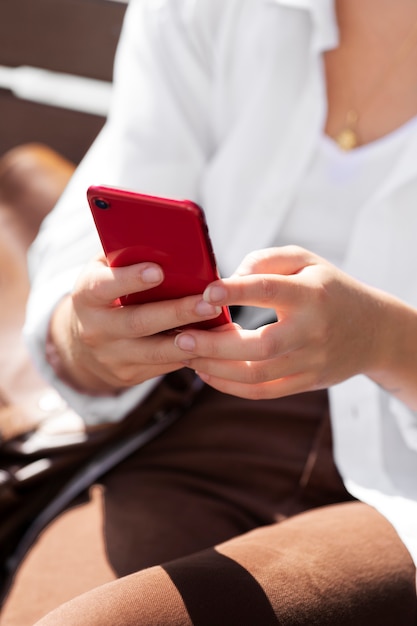 Free Photo close up woman holding smartphone