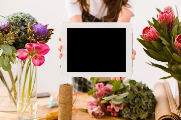 Close-up woman holding a tablet indoors