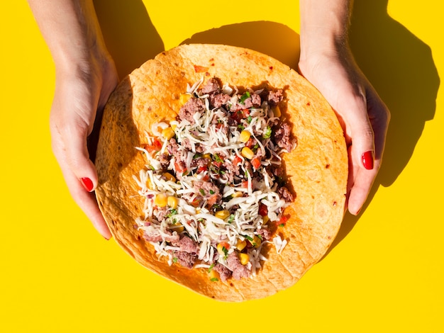 Free photo close-up woman holding unfolded burrito