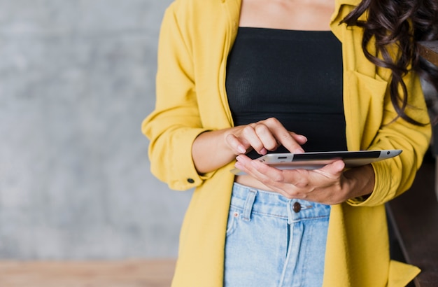 Close-up woman holding up a tablet