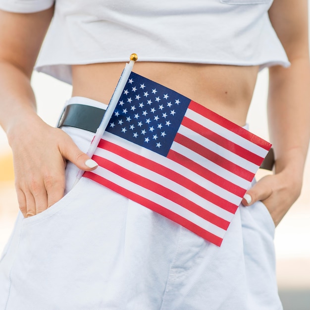 Close-up woman holding usa flag in pocket