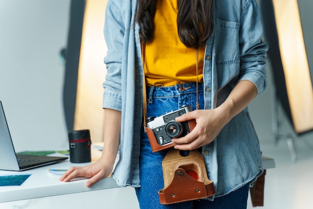 Free photo close-up woman holding vintage camera