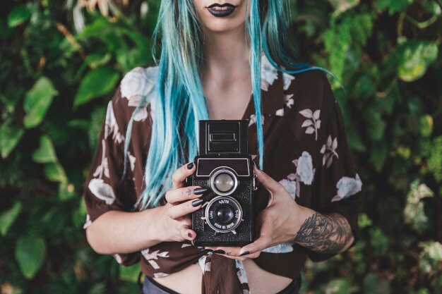 Close-up of woman holding vintage old camera