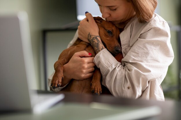 Close up on woman hugging her pet dog