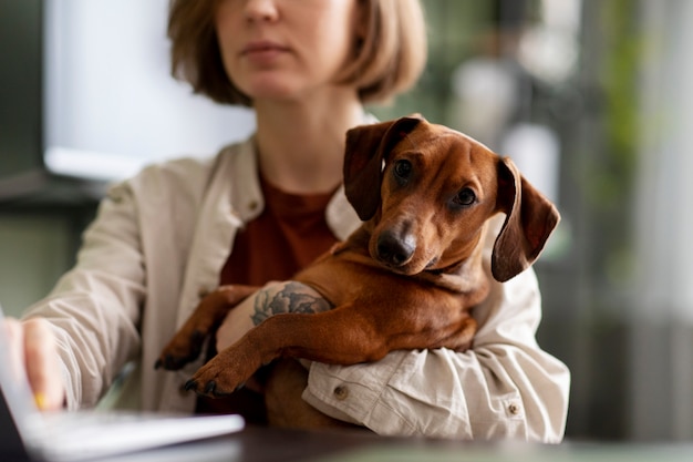 Close up on woman hugging her pet dog