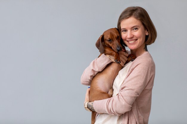 Close up on woman hugging her pet dog