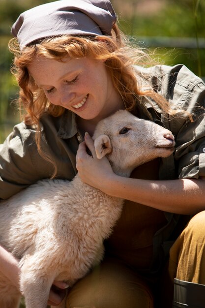 Close up woman hugging lamb