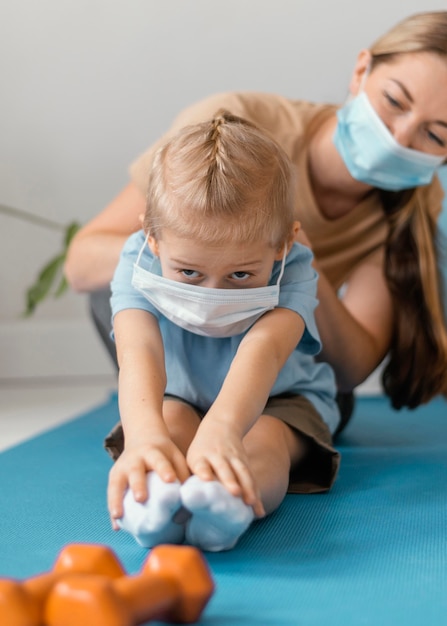 Close-up woman and kid wearing face masks