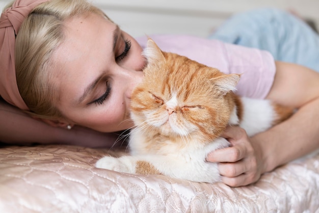 Free Photo close up woman kissing cute cat