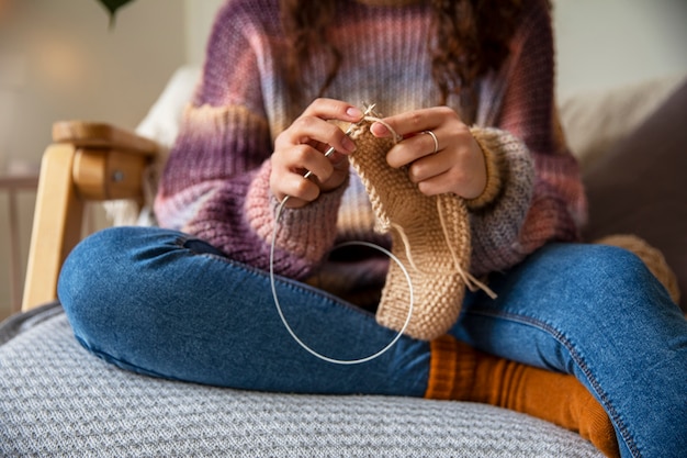 Free photo close up woman knitting at home