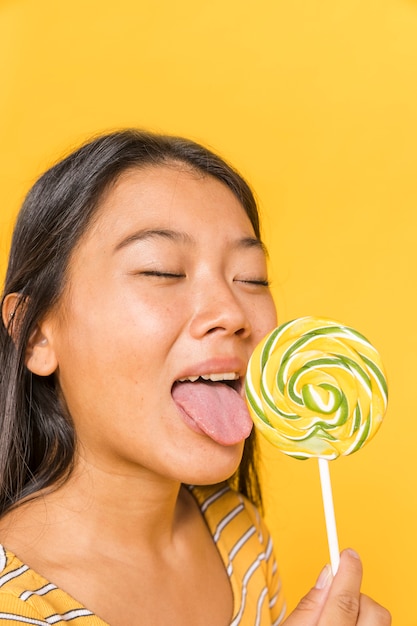 Free Photo close-up woman licking a lollipop 