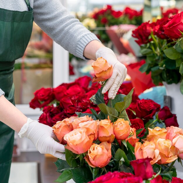 Close-up woman looking after flowers