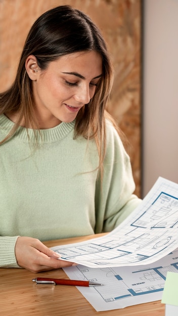 Free photo close-up woman looking at plans