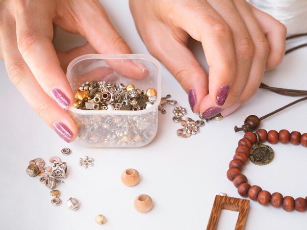 Close-up of woman making accessories