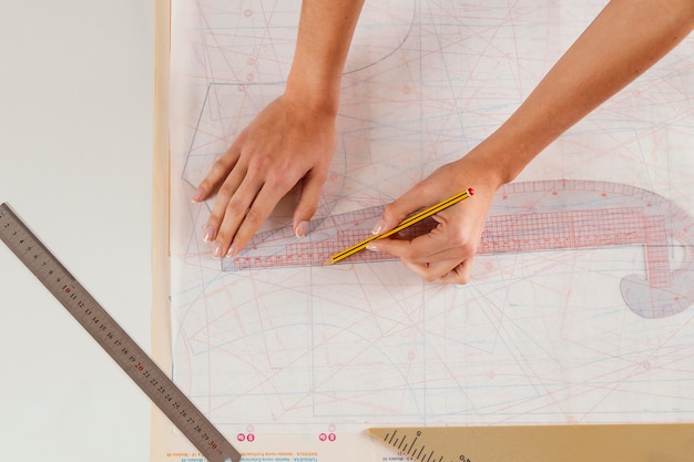 Free Photo close-up woman measuring with ruler