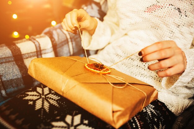 Close-up of woman opening a gift