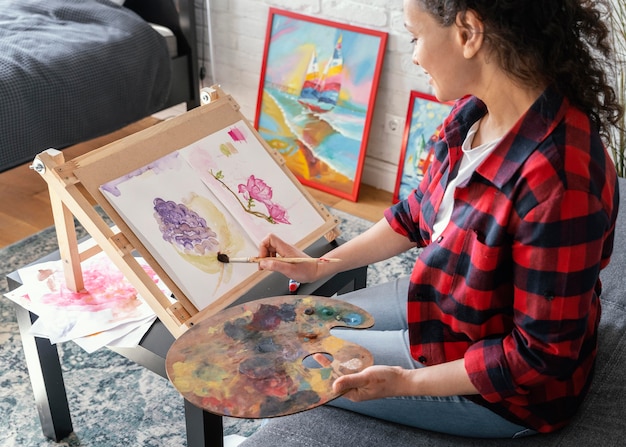 Close up woman painting at home