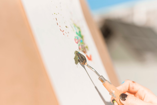 Close up of woman painting outdoors