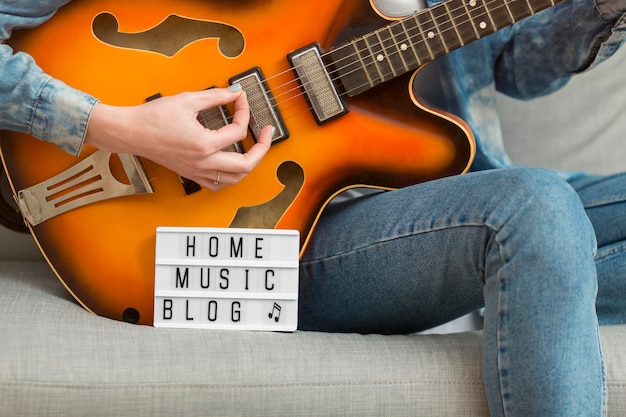 Free photo close-up woman playing guitar at home