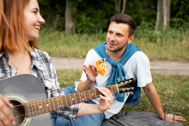 Free photo close up woman playing the guitar