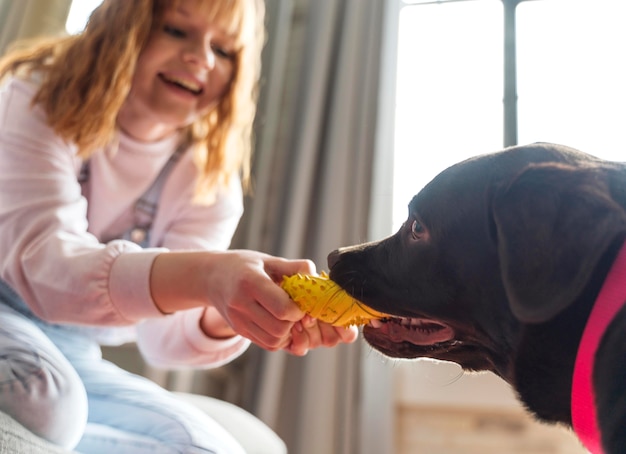 Free Photo close up woman playing with dog