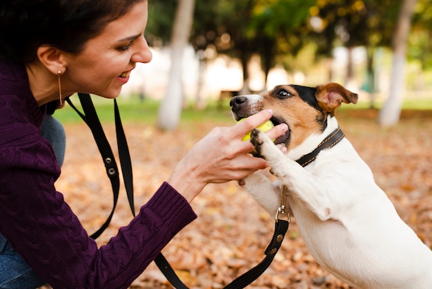 Close-up woman playing with her dog