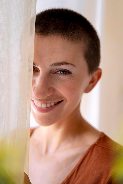 Close up woman posing behing curtain