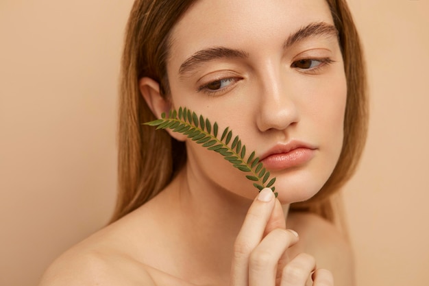 Free photo close up woman posing with twig