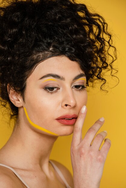 Close-up woman posing with yellow background