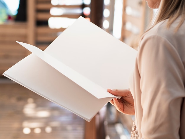 Close-up woman reading a mock-up magazine