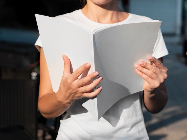 Close-up woman reading a mock-up magazine