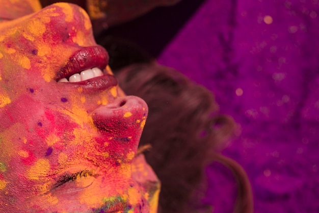 Free photo close-up of a woman's face covered with holi color