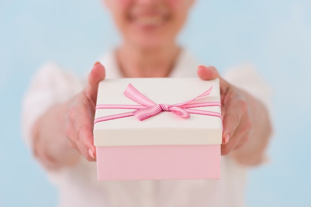 Close-up of woman's hand giving gift box