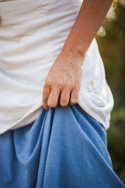 Close-up of woman's hand holding dress