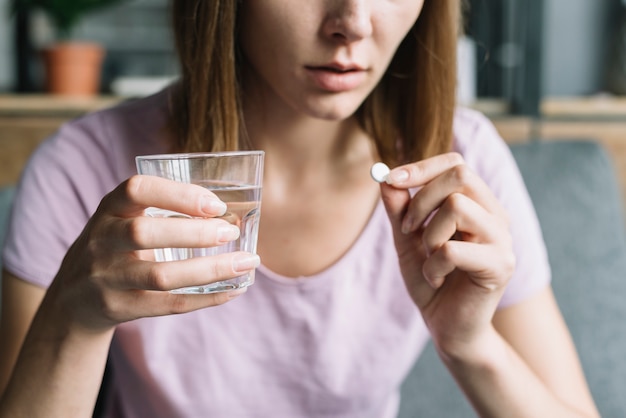 Free Photo close-up of a woman's hand taking medicine