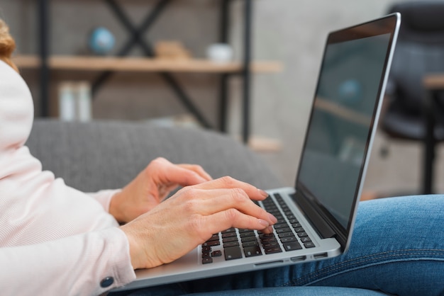 Free Photo close-up of woman's hand typing on laptop