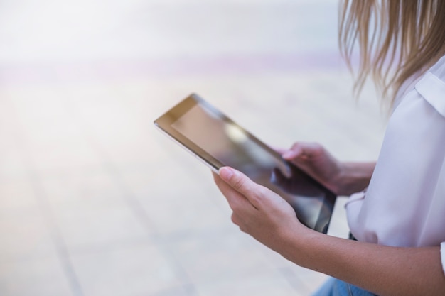 Close-up of a woman's hand using digital tablet