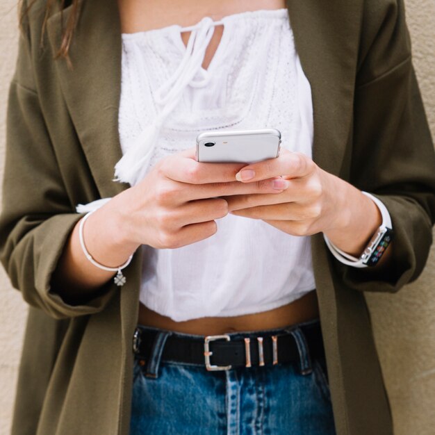 Close-up of a woman's hand using smartphone