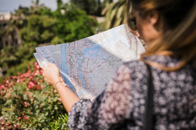 Close-up of woman searching right direction on map