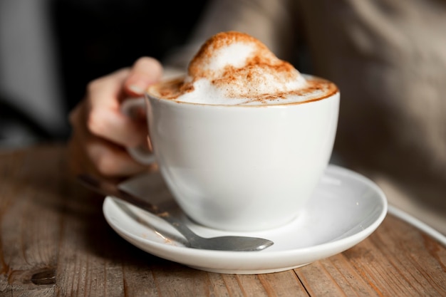 Close-up woman serving cop of coffee