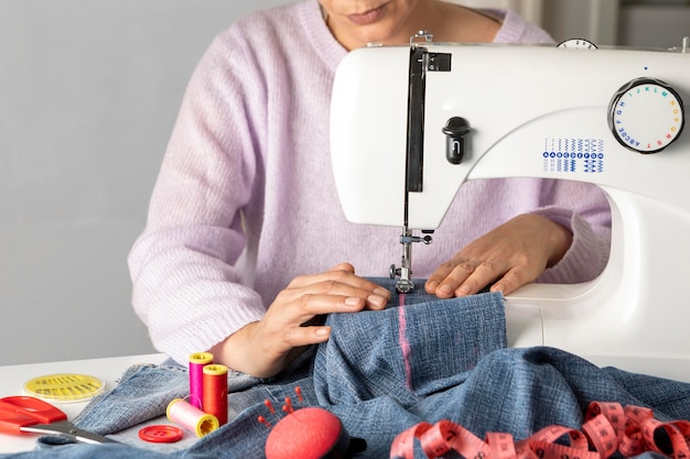 Close-up woman sewing with machine