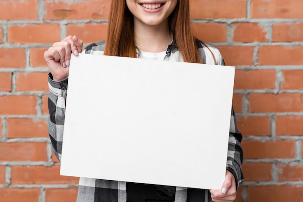 Close up woman showing empty paper