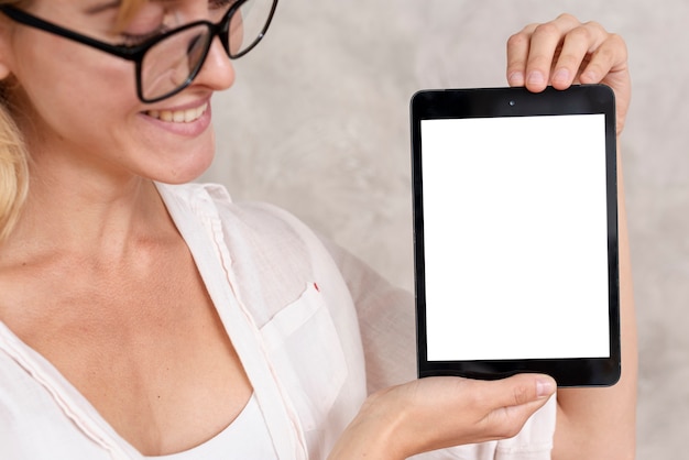 Close-up woman showing a tablet with mock-up