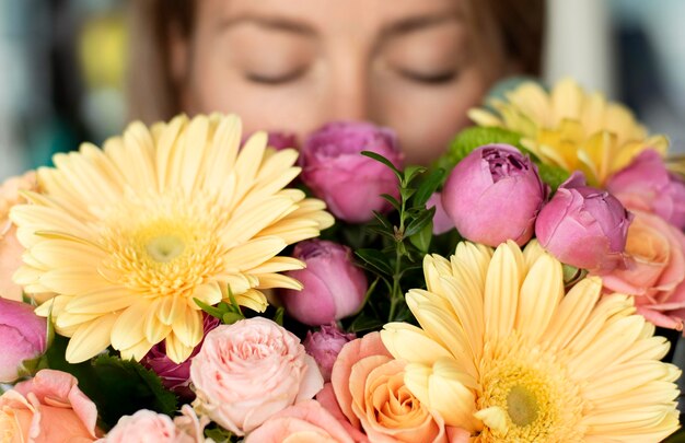 Close up woman smelling flowers