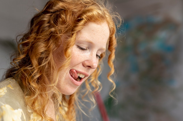 Close-up woman sticking her tongue out 