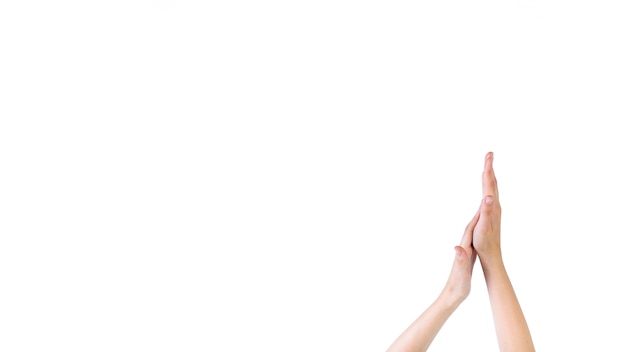 Close-up of a woman touching her palm on white background