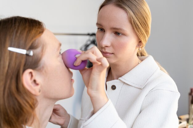 Close up woman using beauty blender