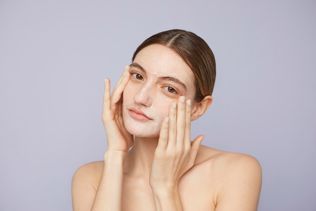 Free photo close up woman using facial mask